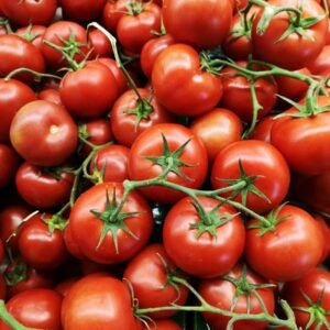 red tomatoes on brown wooden table